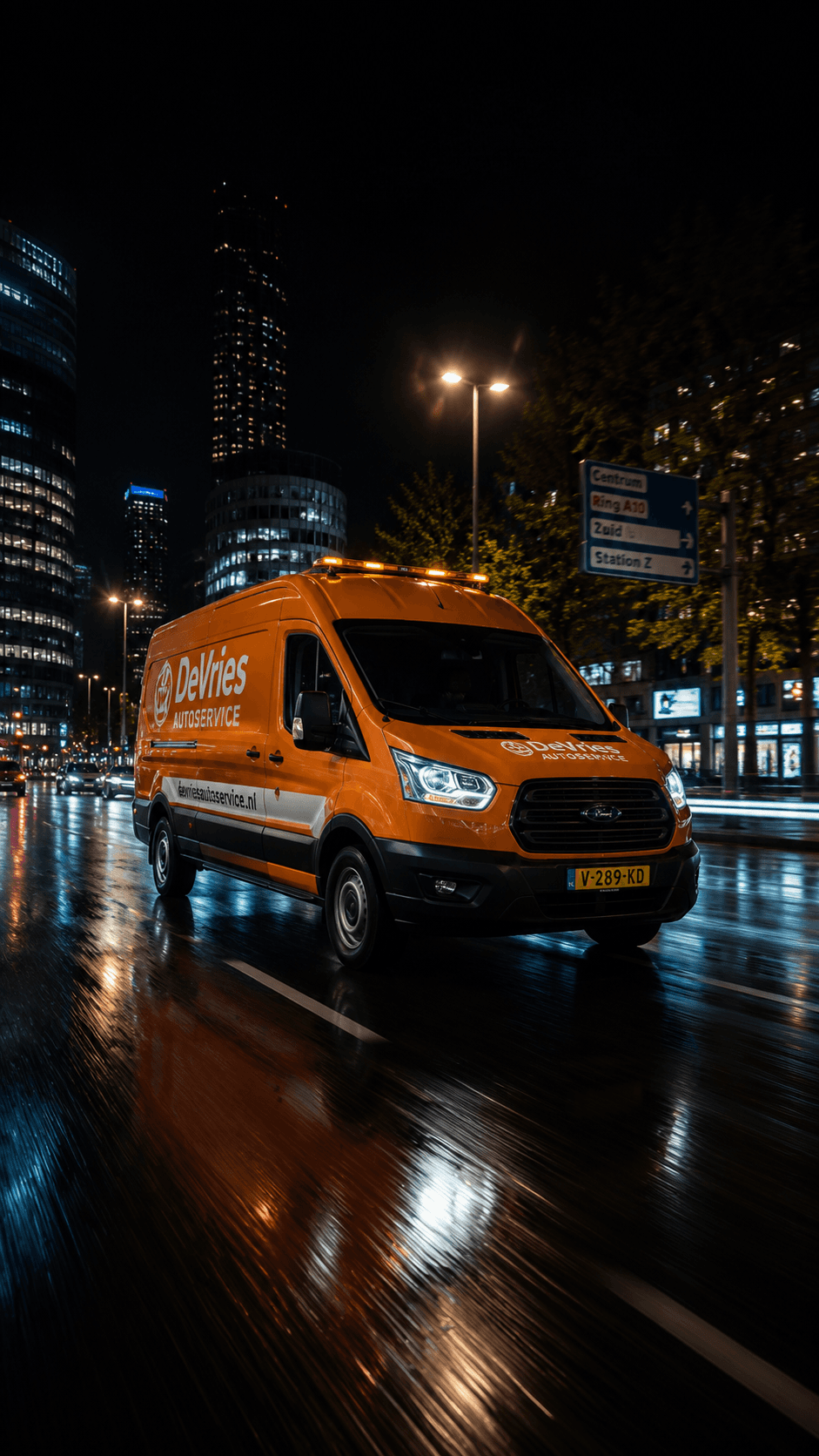 Servicebus van De Vries Autoservice rijdt 's nachts door de stad
